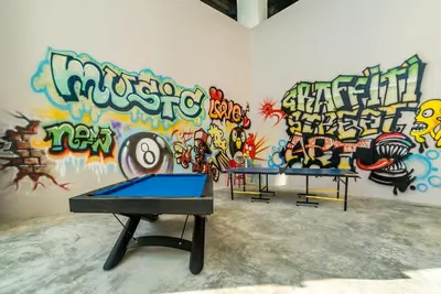 two ping pong tables in front of a wall with graffiti at Sea view studio near Tri Trang & Merlin beach in Patong Beach