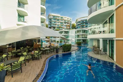 a person swimming in a swimming pool in a building at Sea view studio near Tri Trang & Merlin beach in Patong Beach