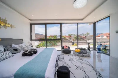 a bedroom with a large bed and a large window at BangTao 5 Bedrooms 2026 New Modern Private Pool Villa Great Location Close to Bangtao Beach in Ban Thalat Choeng Thale