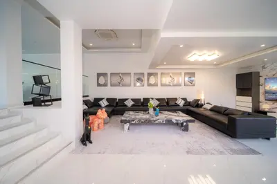 a living room with a black couch and a table at BangTao 5 Bedrooms 2026 New Modern Private Pool Villa Great Location Close to Bangtao Beach in Ban Thalat Choeng Thale