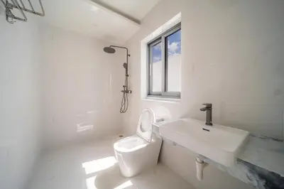 a white bathroom with a sink and a toilet at BangTao 5 Bedrooms 2026 New Modern Private Pool Villa Great Location Close to Bangtao Beach in Ban Thalat Choeng Thale