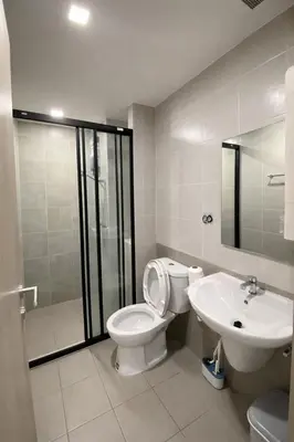 a bathroom with a toilet and a sink at Modern Apartment with Pool & Gym in Kathu