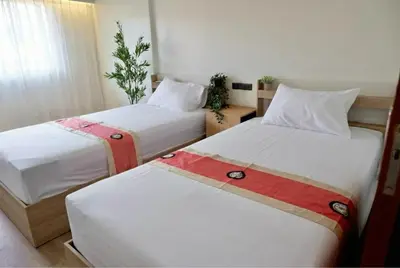 a hotel room with two beds with white sheets at Tree House in Ban Rangeng