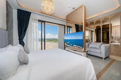 a bedroom with a large bed and a large screen television at Apartment in Laguna perfect location in Laguna Phuket