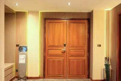 a large wooden door in a room at Bauman Residence in Patong Beach