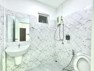 a white bathroom with a sink and a toilet at Home in Chalong 3 Bedrooms Fully Furnished in Ban Suan