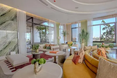 a living room with a couch and tables and windows at Canvas 11112 Cozy 2BR Residence in Phuket Town