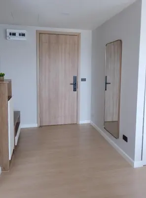 an empty room with two doors and a mirror at Stylish 2BR condo in the heart of Bang Tao in Ban Thalat Choeng Thale