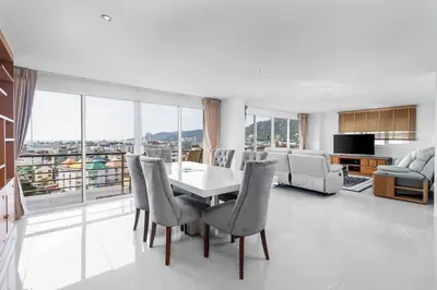 a living room with a dining room table and chairs at C265 Great Ocean View 2BR Pool & Gym Near Beach in Patong Beach