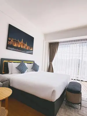 a hotel room with a large bed and a window at Phuket gateway inn in Kathu