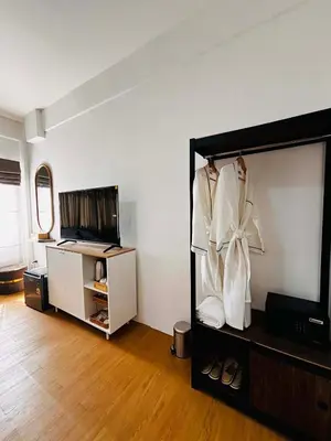 a living room with a closet with white clothes at Phuket gateway inn in Kathu