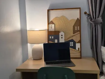 a laptop computer sitting on a desk with a lamp at Phuket sun n soul House in Ban Tha Rua