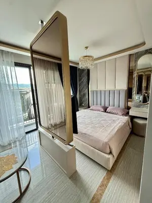 a bedroom with a large bed and a chandelier at Stylish Apartments in a New Boutique Complex in the Laguna in Laguna Phuket