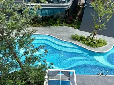 a swimming pool with blue water in a building at Stylish Apartments in a New Boutique Complex in the Laguna in Laguna Phuket