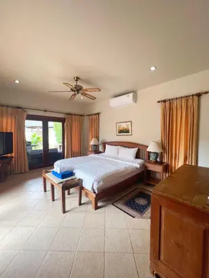 a bedroom with a bed and a ceiling fan at Luxury 3-bedroom villa with pool in Rawai in Rawai Beach