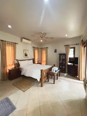 a bedroom with a large bed and a ceiling fan at Luxury 3-bedroom villa with pool in Rawai in Rawai Beach