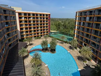 an overhead view of a swimming pool with palm trees and buildings at FAMILY HOMES Panoramic Pool View Studio in Mai Khao CB-706 in Ban Mai Salae