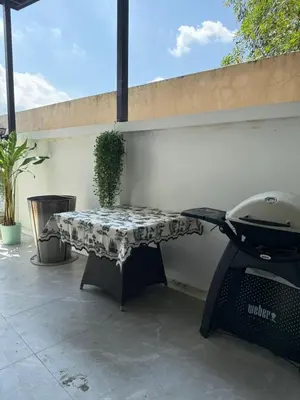 a grill sitting on a patio with a table at Villa Bang Tao Ananda Lake View in Ban Pak Lak