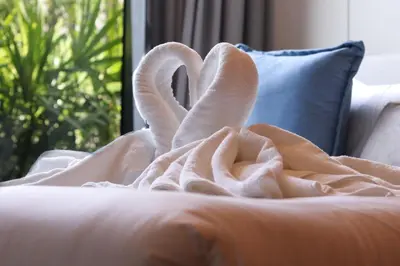 a swan blanket on top of a couch at Canvas 1112 TwoBedroom Residence in Phuket Town