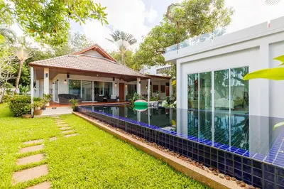 a house with a swimming pool in front of it at Peaceful Villa 12 mins to Bangtao & Layan Beach in Ban Pak Lak