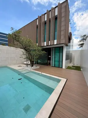 a house with a swimming pool in front of a building at New 3 Bed Villa Mono Oxygen Bangtao in Ban Thalat Choeng Thale