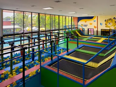 a large indoor play area with slides and water play equipment at Love Rawai Hotel in Rawai Beach