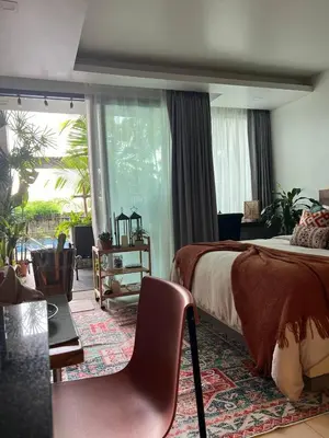 a bedroom with a bed and a table and chairs at Spacious studio with big patio ! in Rawai Beach