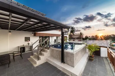 a house with a swimming pool on a patio at Surin Sabai in Surin Beach