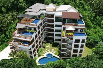 an aerial view of a building with a swimming pool at Surin Sabai in Surin Beach