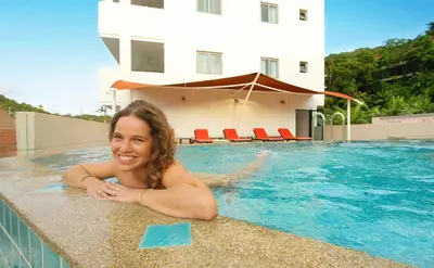 a young woman laying in a swimming pool at Surin Sabai in Surin Beach