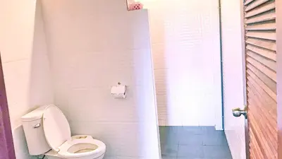 a bathroom with a toilet and a shower at Abbas House by Swiss Chalet, 2-room Cottages in Krabi town