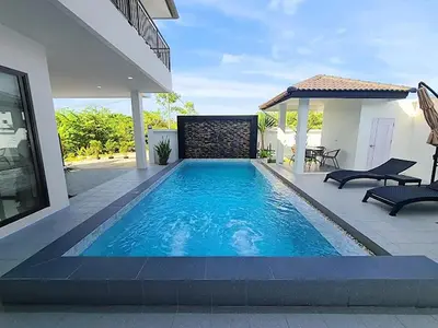a swimming pool in the backyard of a house at Jitvirat Pool Villa in Ban Nong Chaeng