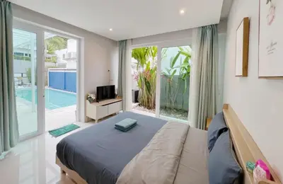 a bedroom with a bed and a large window at 3bedrooms pool Villa Kamala in Kamala Beach
