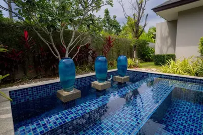 a row of blue vases sitting in a swimming pool at Beautiful Pool Villa in Pavilion and Tropical Oasis in Ban Pak Lak