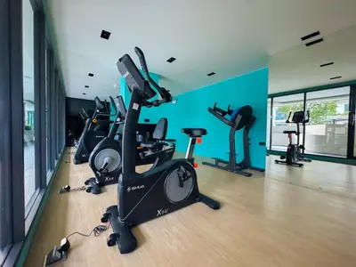 a gym with several treadmills and exercise bikes at Comfortable 2Bdr Bangtao Space Condo in Ban Thalat Choeng Thale