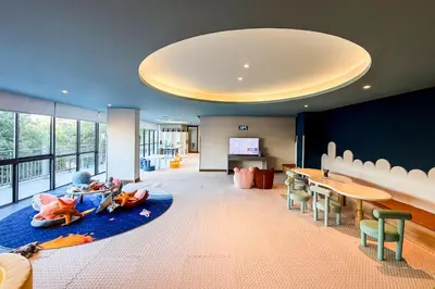 a large living room with a table and chairs at The Sunshine Beach studio with a great view in Layan Beach