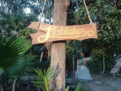 a wooden sign hanging on a tree at Kohyaonoi Lastfisherman in Ko Yao Noi