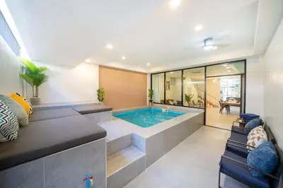 a swimming pool in the middle of a house at New Modern Escape Patong Poolvilla 2 mins to beach in Patong Beach