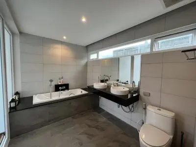 a bathroom with two sinks and a tub and a toilet at Pool Villa in Phuket 3rooms for family in Kamala Beach