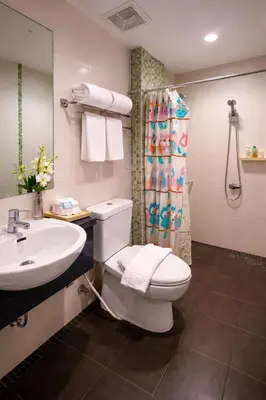 a bathroom with a toilet and a sink and a shower at Aura Inn in Patong Beach