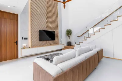 a living room with a couch and a tv at V293 Be the First! Brand New Elite Pool Villa in Ban Thalat Choeng Thale