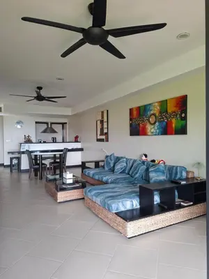 a living room with a couch and a ceiling fan at The Aspasia Kata Beach in Kata Beach