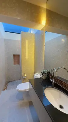 a bathroom with a sink and a toilet and a mirror at ozone pool villa phuket in Ban Pa Khlok
