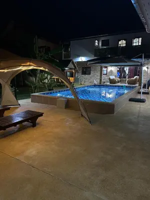 a large swimming pool in a building with a tent at Luxury Capsule Haus Phuket in Panwa Beach