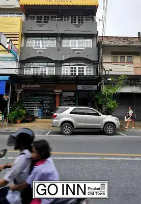 a silver car parked in front of a building at GO INN Phuket old Town in Ban Lo Long