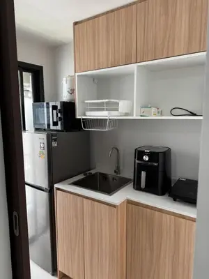a kitchen with a sink and a refrigerator at VIP Great Hill Airport in Phuket
