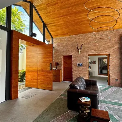 a living room with a leather couch and a wooden ceiling at Golf Paradise 4 BR Smart Home Pool Villa at Loch Palm Golf Course Kathu in Ban Kathu
