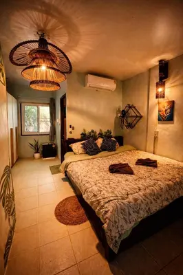 a bedroom with a large bed and a chandelier at MILD ISLAND STAY ROOm in Phi Phi Don