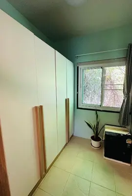 a kitchen with a window and a plant in the corner at MILD ISLAND STAY ROOm in Phi Phi Don