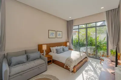 a bedroom with a bed and a couch at Taraburi 6BR Pool Villa Phuket VVPHU91 in Thalang